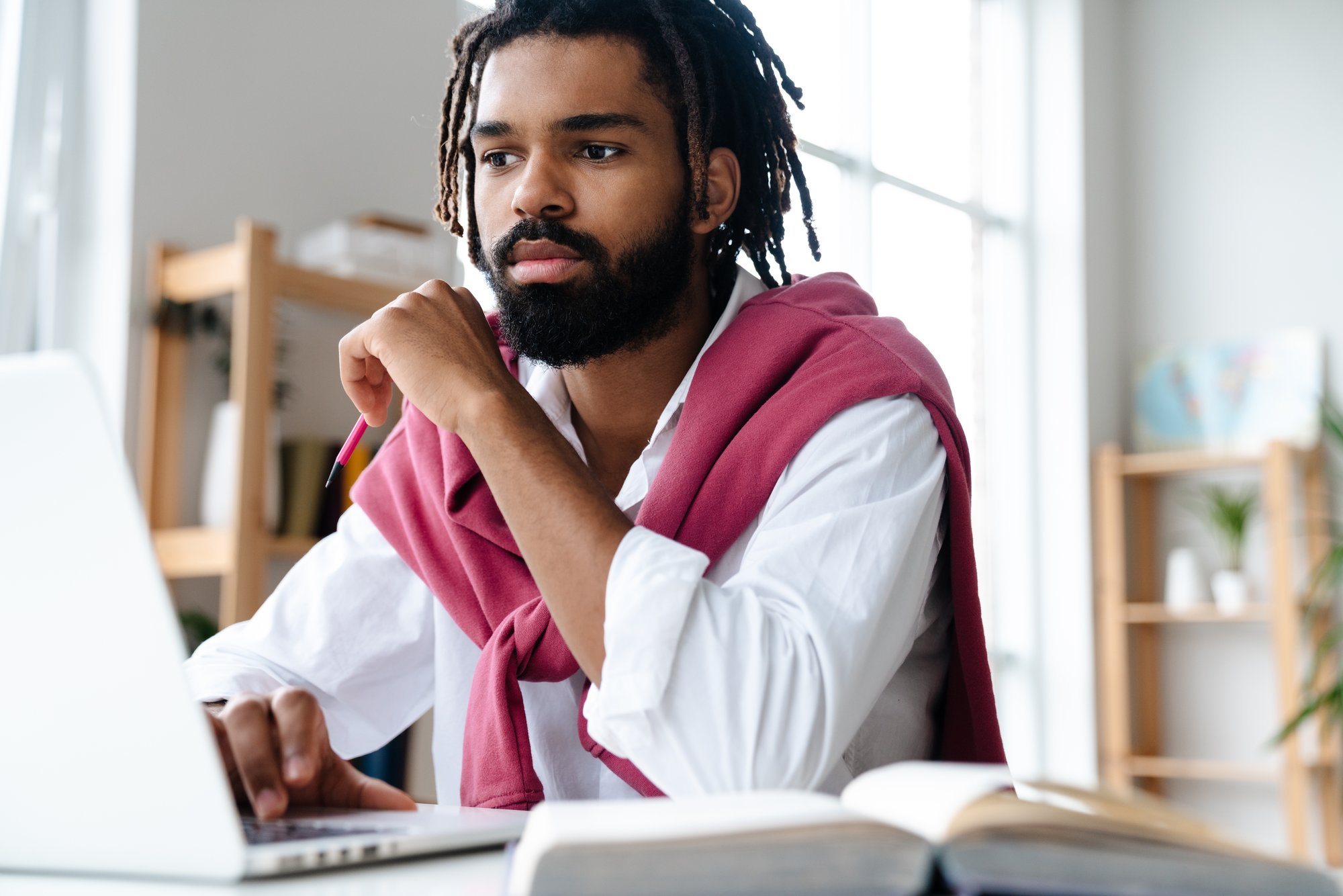 focused-african-american-guy-working-with-laptop-a-2023-11-27-05-26-19-utc