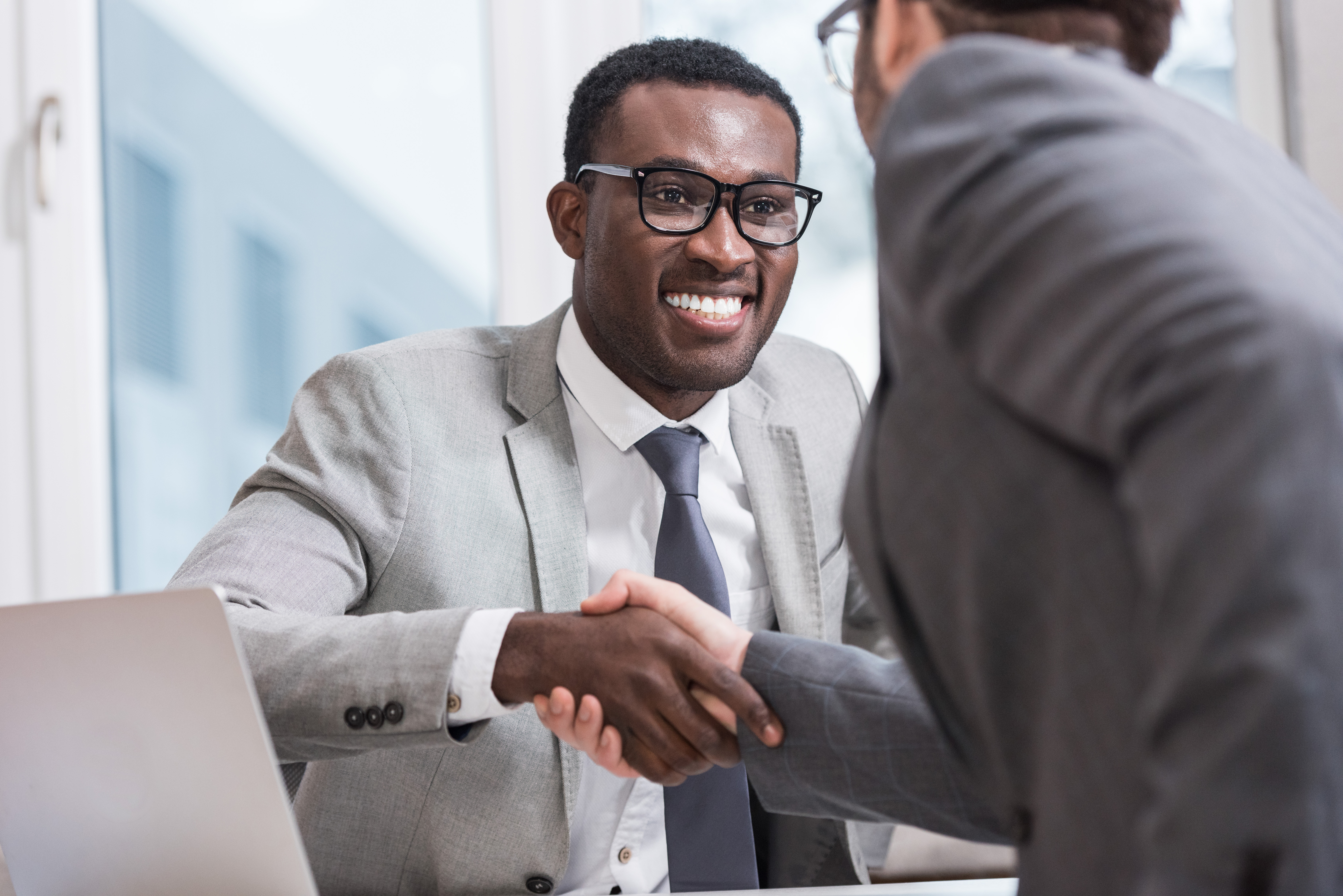 close-up-view-of-smiling-multiethnic-businessmen-s-2023-11-27-05-19-24-utc